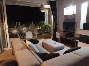 a living room with a couch and a tv at B&B Alle Calende Greche in Martignano