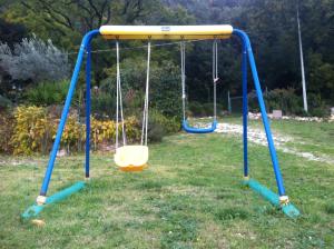 an empty swing set in a yard at B&b La Casa Del Sole in Borgaria