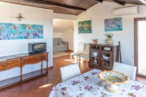 a living room with a table and a tv at Casa Andrea in Marina di Ragusa