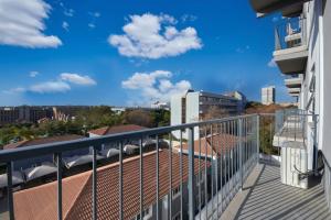 a balcony with a view of the city at The Base Apartment in Johannesburg