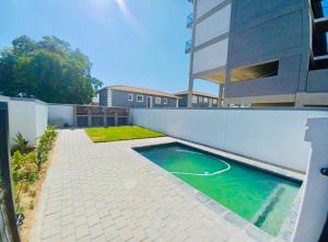a swimming pool on the side of a building at The Base Apartment in Johannesburg
