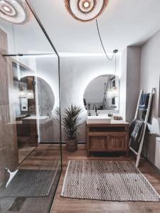 a bathroom with a shower and a sink and a mirror at Feels like home Two Bedrooms in Ralingen