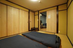 Postel nebo postele na pokoji v ubytování Guest House 伏見稲荷