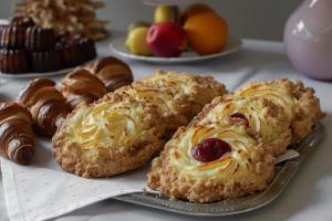 a group of pastries and croissants on a table at Best Palanga Hotel in Palanga