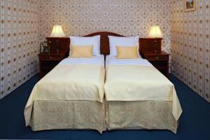 Ένα ή περισσότερα κρεβάτια σε δωμάτιο στο Hotel MERTIN