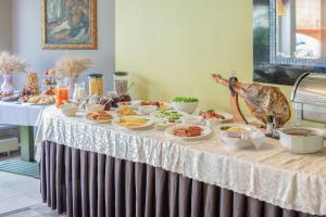 a table with food on top of a table at Best Palanga Hotel in Palanga