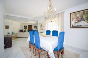 a dining room with a table and blue chairs at White Star Estoril in Estoril
