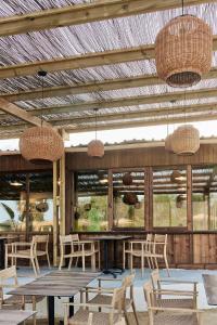 a patio with a table and chairs and lights at TAIGA Almeria Playa in Palomares
