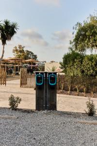 a couple of blue toilets sitting in the gravel at TAIGA Almeria Playa in Palomares