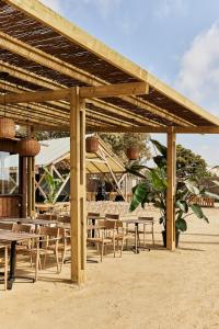 a group of tables and chairs under a pavilion at TAIGA Almeria Playa in Palomares