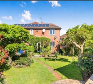 a house with solar panels on top of a yard at Doncaster Dream House Retreat- Sleeps 9 in Doncaster
