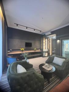 a living room with two couches and a tv at Sapar Standart Hotel LUXE Люкс из двух комнат in Shymkent +11 photos