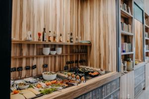 a buffet line with food and bottles on shelves at Science Hotel Prémium in Szeged