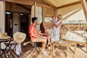 a family is sitting in a living room at TAIGA Almeria Playa in Palomares