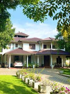 a house with a car parked in front of it at Golden Residence in Anuradhapura