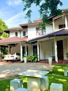 a house with a car parked in front of it at Golden Residence in Anuradhapura