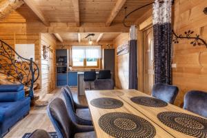 a dining room with a table and chairs at Leśny Dwór Premium Chalets Zakopane in Murzasichle