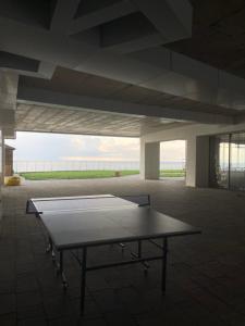 a ping pong table sitting inside of a building at Cozy Flat At Bamboo Beach Tsikhisdziri in Tsikhisdziri