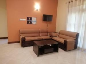 a living room with a couch and a coffee table at Golden Residence in Anuradhapura