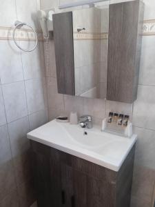 a bathroom with a sink and a mirror at Studio Poseidon in Leipsoi +31 photos