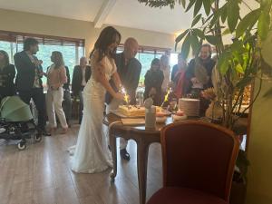 a bride and groom cutting their wedding cake at Logis Hotel Restaurant Le Grand Puech in Mimet