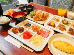 a table with several trays of food on it at Granbell Hotel Osaka in Osaka