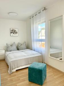 a bedroom with a bed and a large mirror at Sonnenoase in Sigmaringen in Sigmaringen