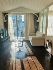 a living room with a couch and a table at Grand Florida Beach condo in Na Jomtien +25 photos