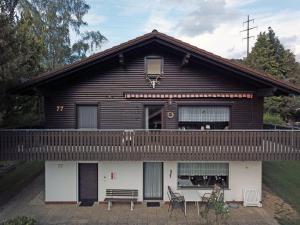 a house with a porch and a balcony at Ferienwohnung Im Lamer Winkel in Arrach +6 photos