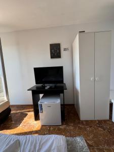 a room with a desk with a computer and a cabinet at Casa Roman II by the sea in Costinesti