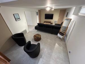 an overhead view of a living room with a couch and chairs at Le domaine du bez gite de Jules piscine,sauna,sauna,hammam,spa in Saint-Laurent-dʼOlt