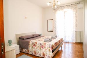 Postel nebo postele na pokoji v ubytování Gli agrumi di Nonna Peppina - Appartamento Limoni