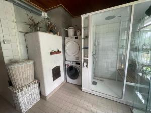 a laundry room with a washing machine and a washer at Villa Kurenniemi in Taipalsaari +34 photos