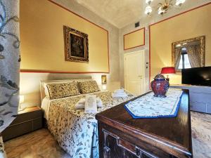 a bedroom with a bed and a table with a vase on it at Domus Clara - guest house Venosa in Venosa