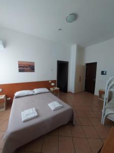 Postel nebo postele na pokoji v ubytování Hotel Acciaroli