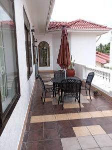 a patio with a table and chairs on a house at SPS Gould Home in Dar es Salaam