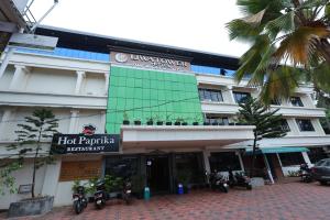 a hotel with motorcycles parked in front of it at Liwa Tower Hotel & Business Center in Kunnamkulam