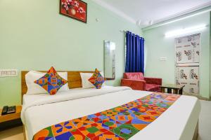 a bedroom with a large bed and a chair at FabHotel Sonnet Inns in Rānchī