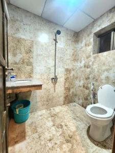 a bathroom with a toilet and a sink at Subtle 1Bed In Bahria Town in Rawalpindi