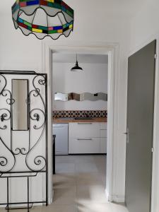 a kitchen with a mirror and a chair at Gîte Villa LORTIN in Pouillon +5 photos