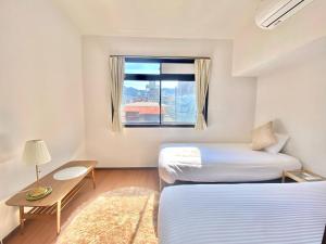A bed or beds in a room at THE MOON Atami