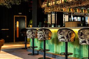 a group of bar stools in front of a counter at The Foundry in Belfast