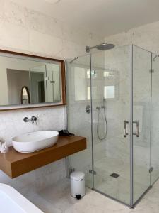 a bathroom with a sink and a glass shower at Le Clos du Cèdre in Saint-Ouen +42 photos