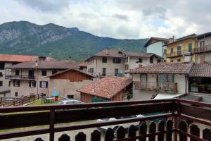 a view of a city with buildings and mountains at Appartamento Verde Lago Ledro in Molina di Ledro +18 photos