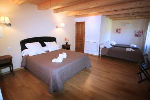 a bedroom with a bed in a room with wooden ceilings at Hotel Restaurant de la Poste in Aullène