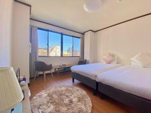 A bed or beds in a room at THE MOON Atami