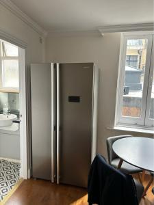 a stainless steel refrigerator in a room with a table at Central quality point piccadilly in London