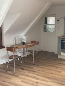 a kitchen with a table and chairs in a room at Joli Studio en centre-ville in Vitré +10 photos