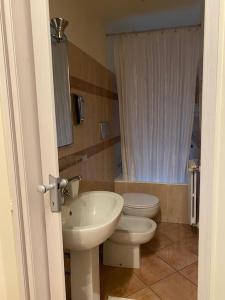 a bathroom with a sink and a toilet at Duomo Prestige in Milan +11 photos
