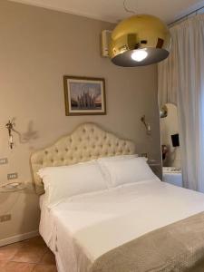 a bedroom with a large bed with a white bedspread at Duomo Prestige in Milan